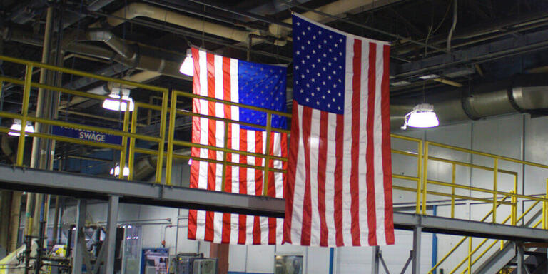 American flags hanging above factory floor