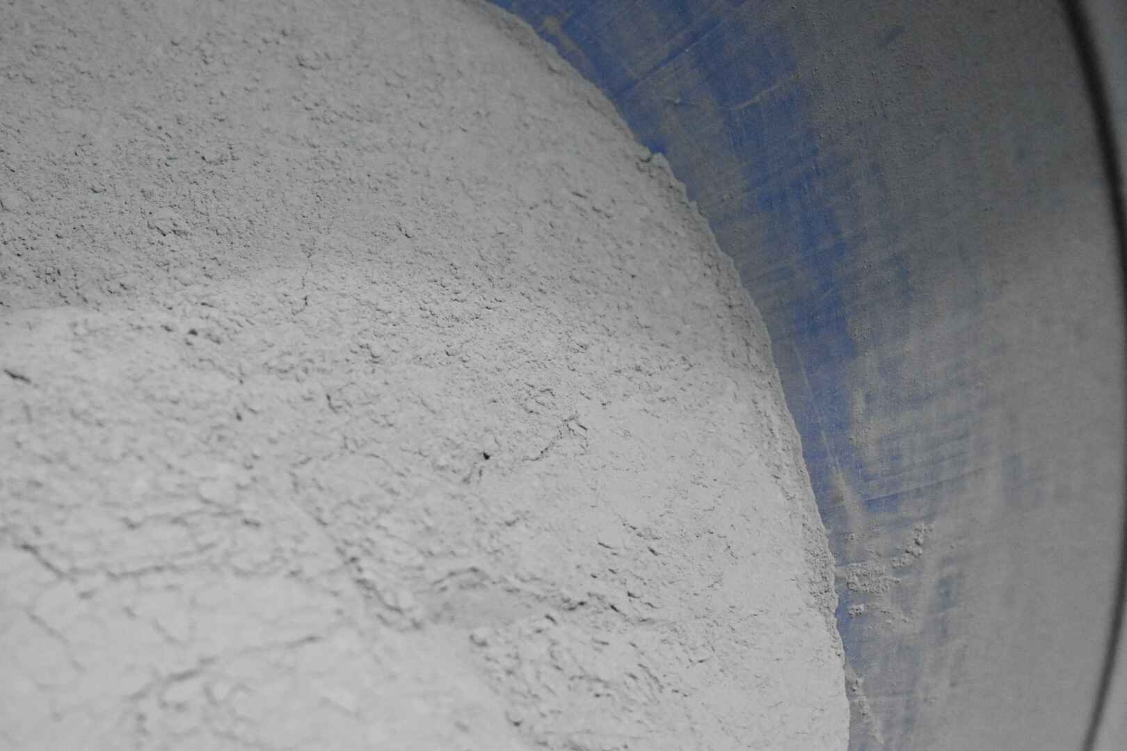 Tungsten powder in blue bucket